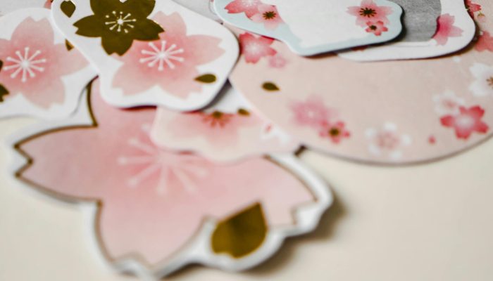 A collection of adorable rabbit and sakura flower stickers arranged on a soft beige surface, perfect for spring decoration.